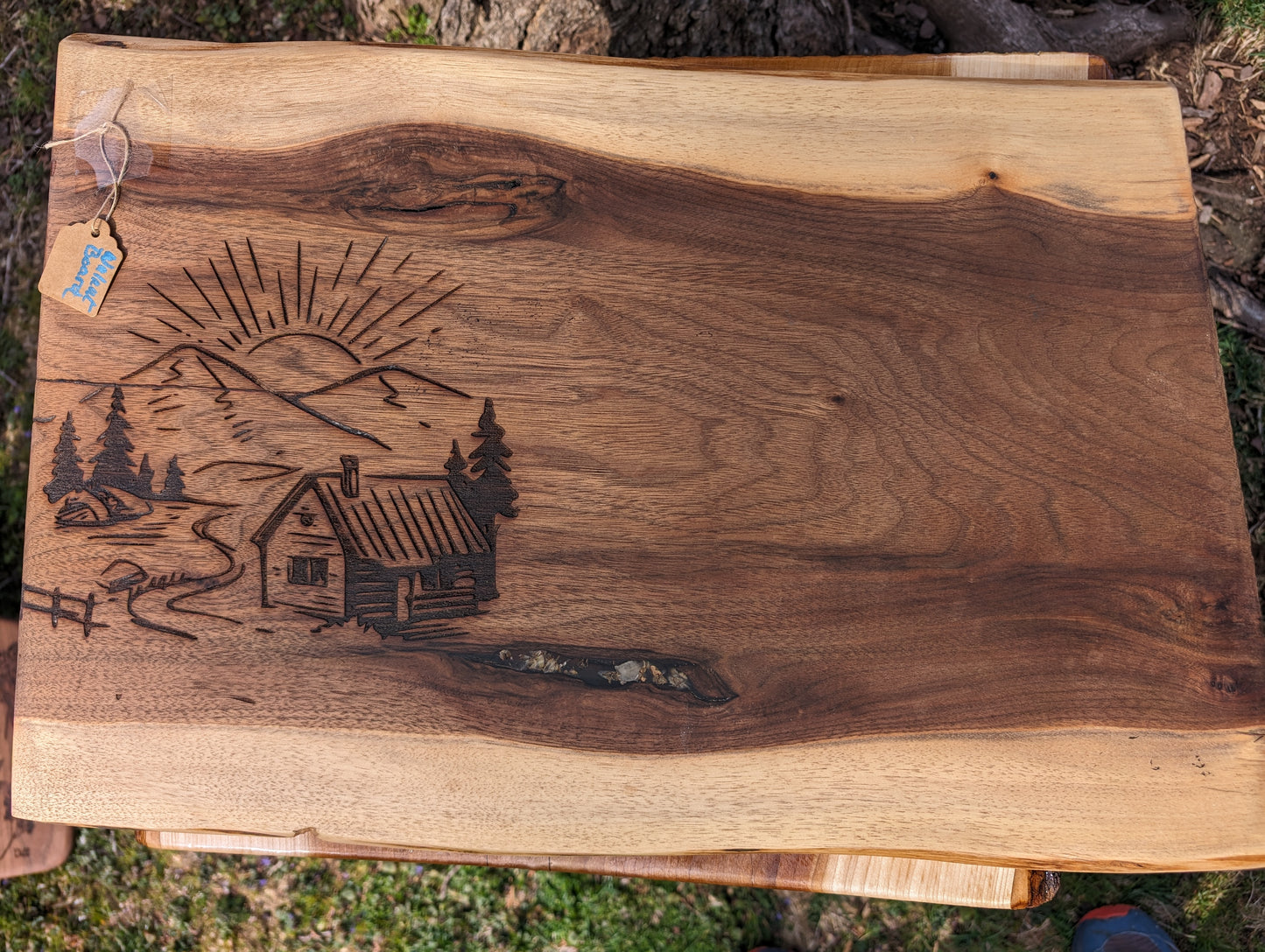 Rising Sun Mountain Cabin Cutting Board on Black Walnut in lay flowers