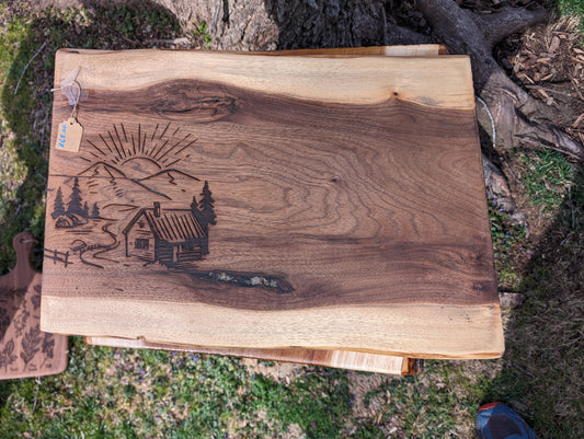 Rising Sun Mountain Cabin Cutting Board on Black Walnut in lay flowers